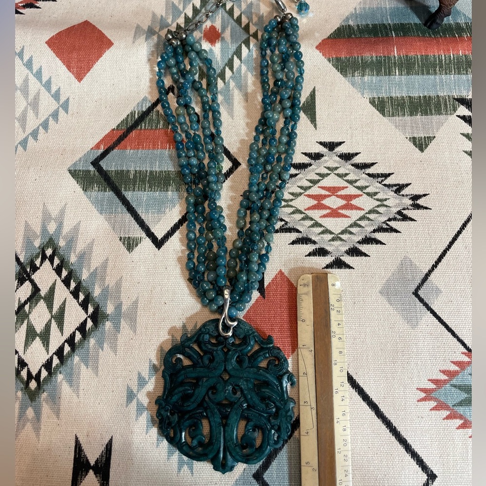 Carved boutique piece in amazonite with many strands and sterling extender.